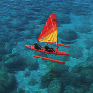 a colorful kite sitting on top of a body of water